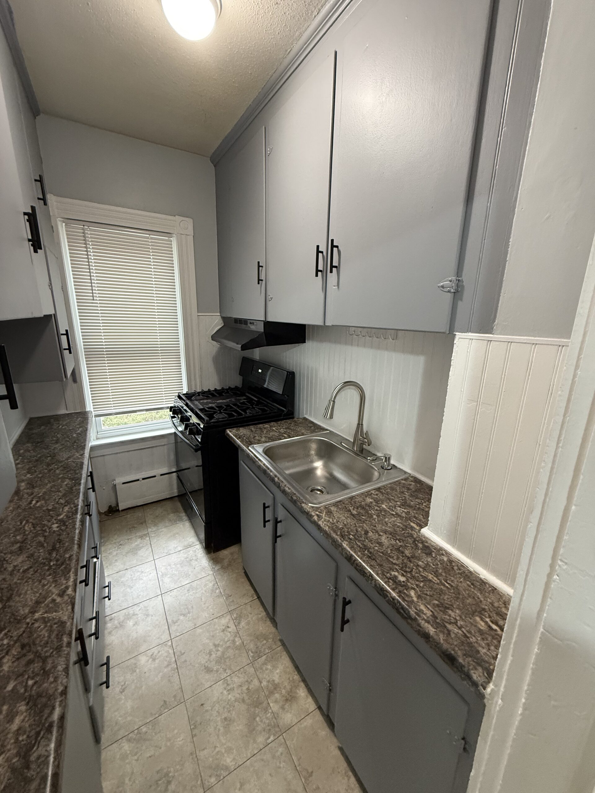 Kitchen with gas stove and stainless sink