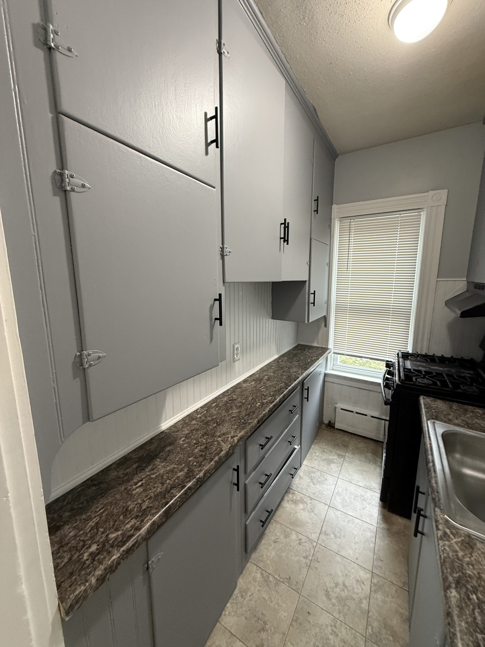 Kitchen cabinet storage with window over the sink