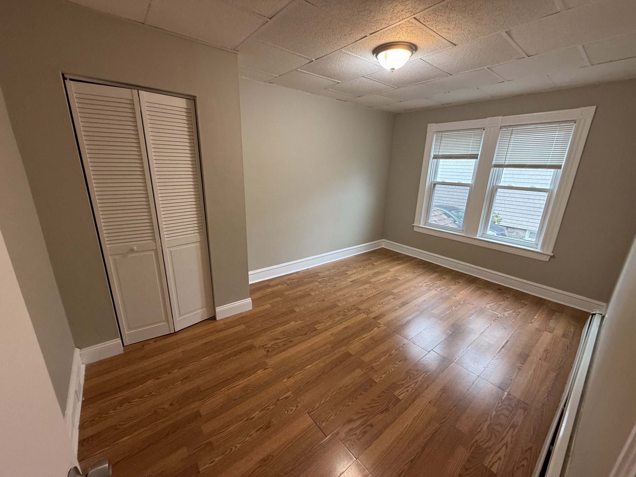 Bedroom 2 with double-hung window and closet