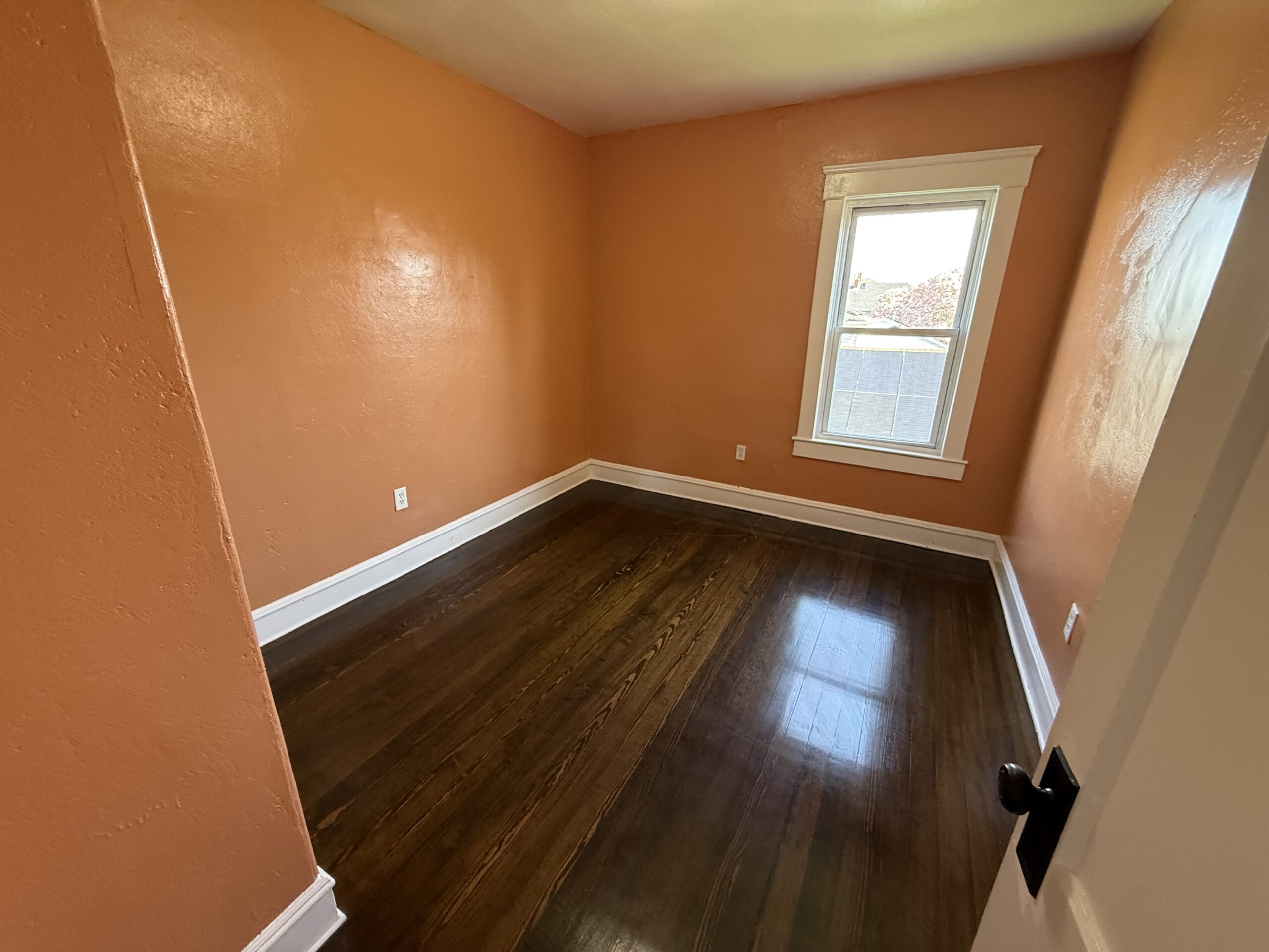 Bedroom with tall single window and dark hardwood floor at 170 King Street, Fall River MA