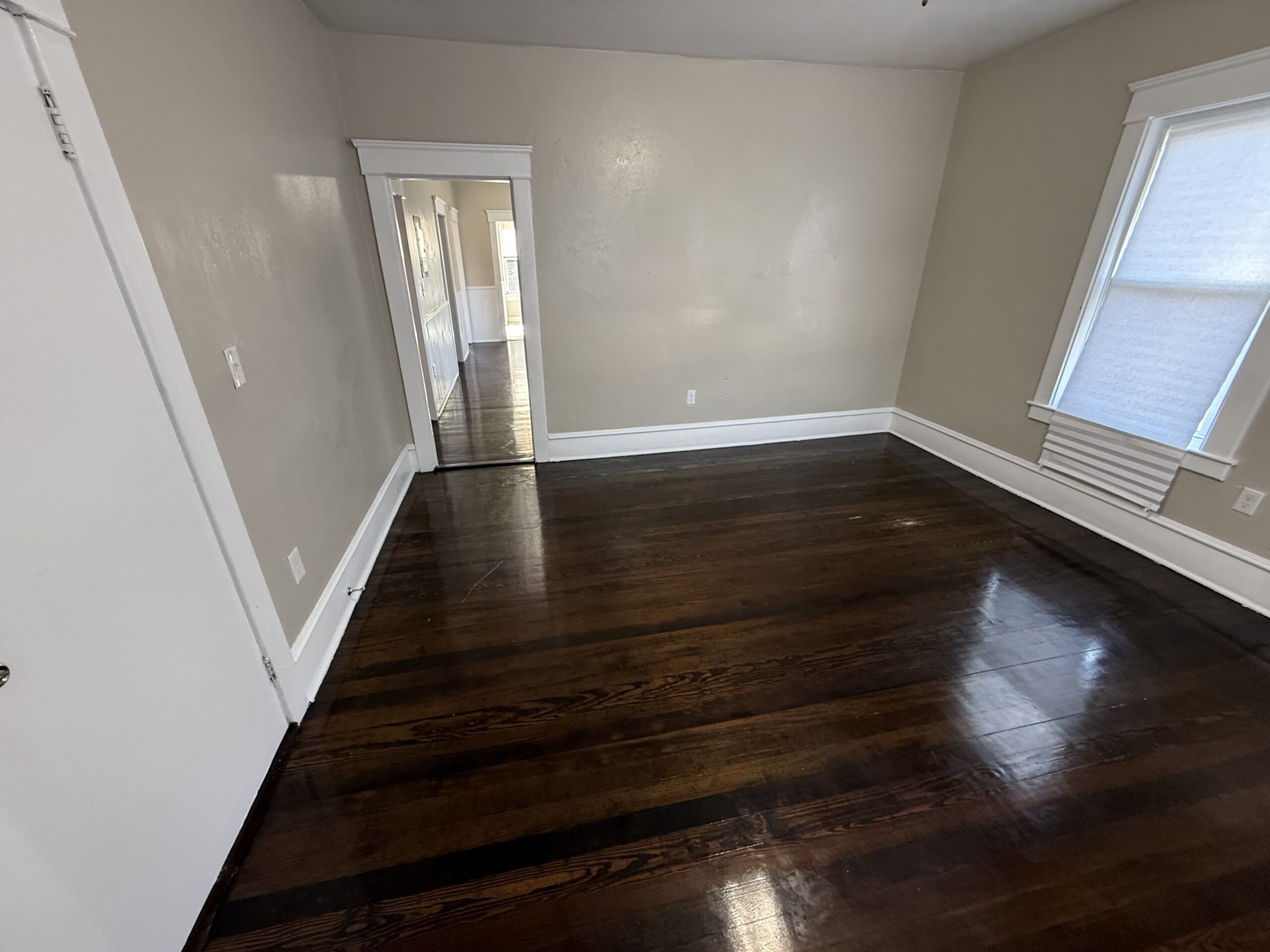 Spacious living room with hardwood floors and view down central hallway at 170 King Street, Fall River MA