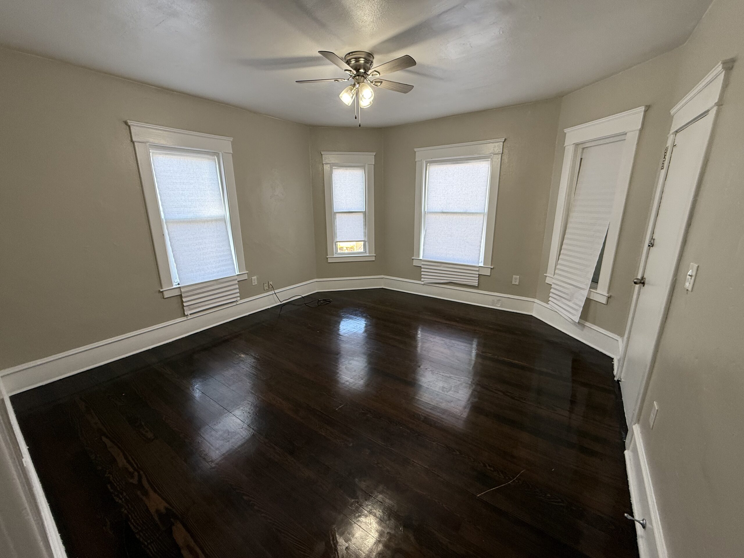 Bright living room with ceiling fan and bay-style windows at 170 King Street Unit 2, Fall River MA
