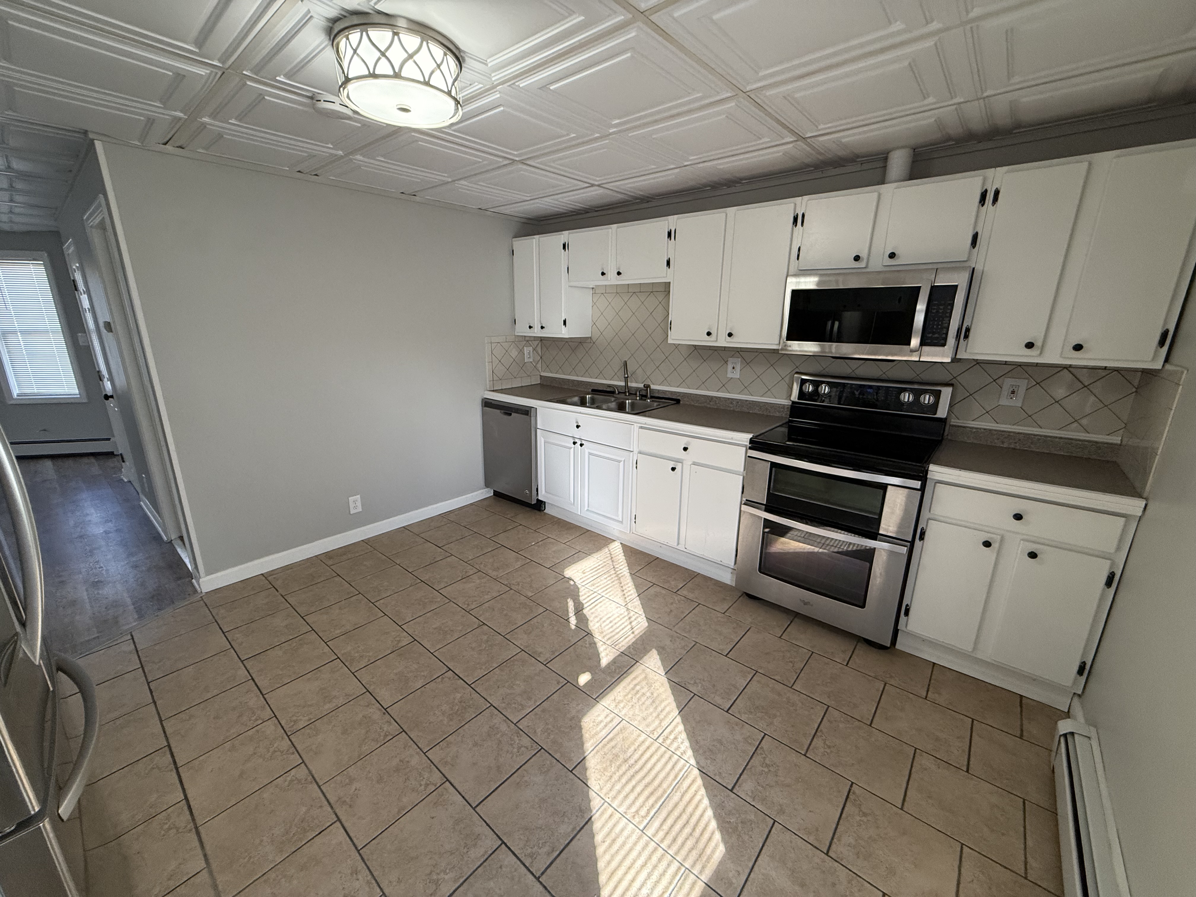 Alternate kitchen angle showing dishwasher and cabinet layout at 41 Donnelly St Apt 2 Fall River