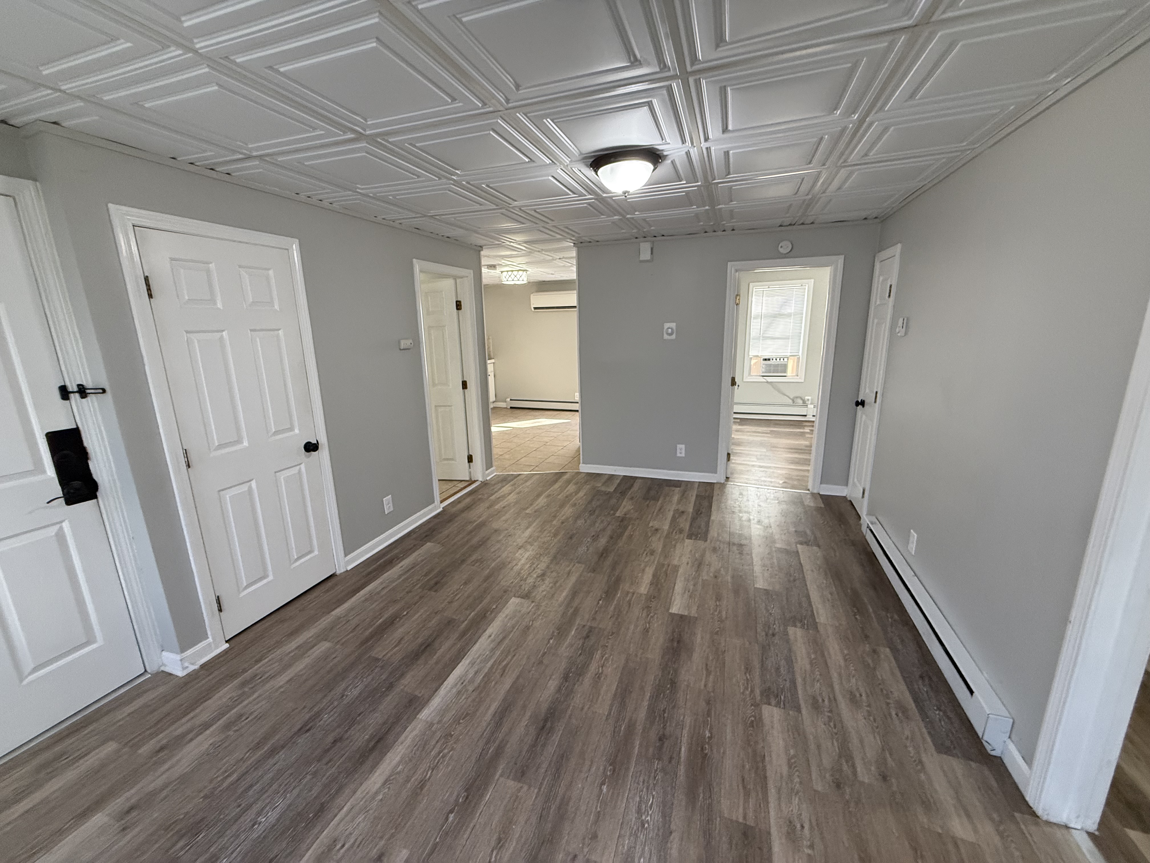 Living room with decorative drop ceiling and vinyl plank floors at 41 Donnelly St Apt 2