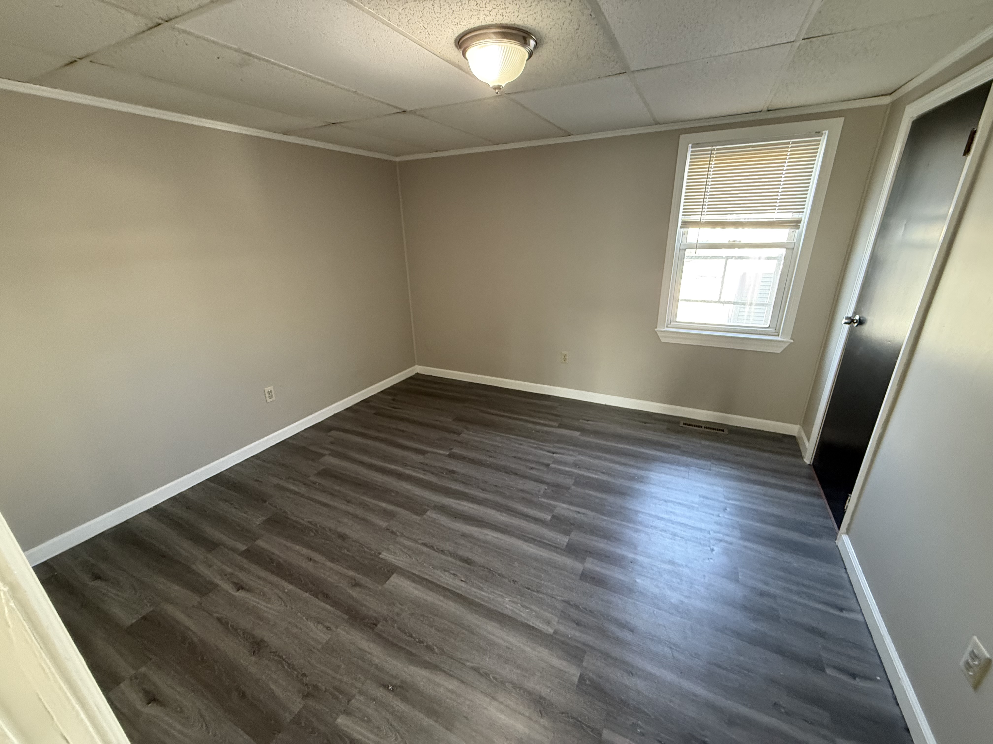 First bedroom with natural light, fits a queen-size bed