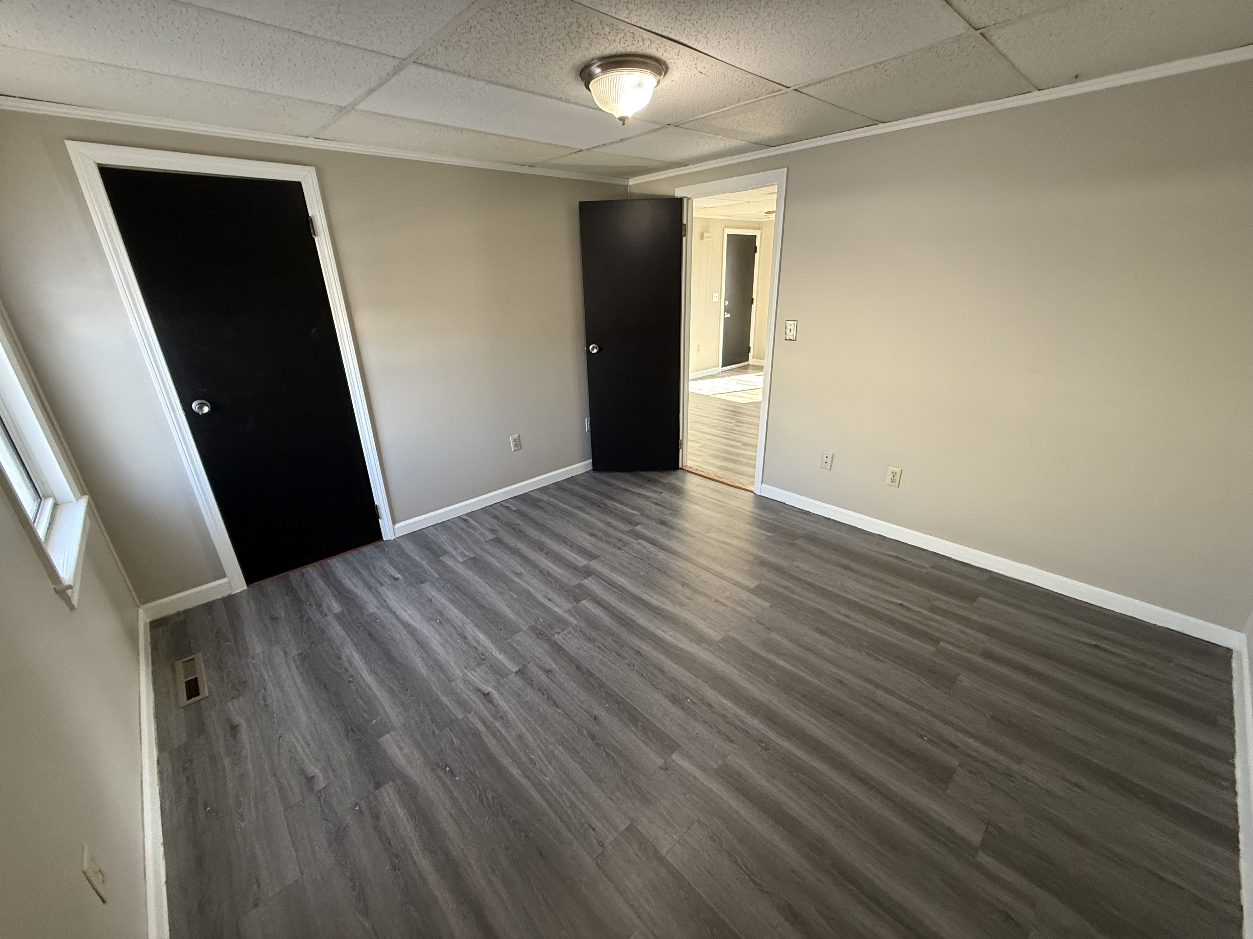 Second bedroom with modern black-painted closet doors