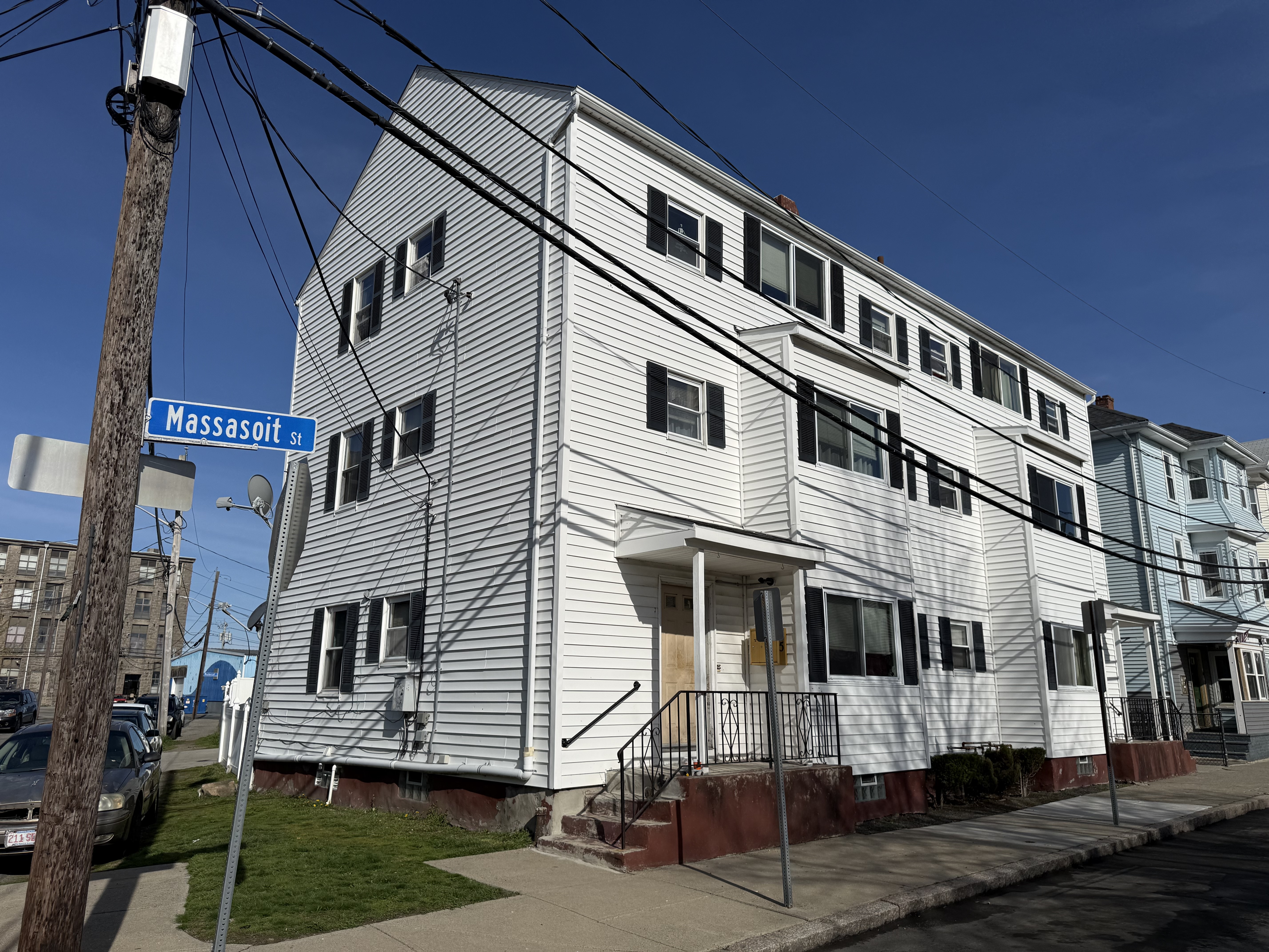 White vinyl siding exterior corner of 77 Massasoit Street building Fall River