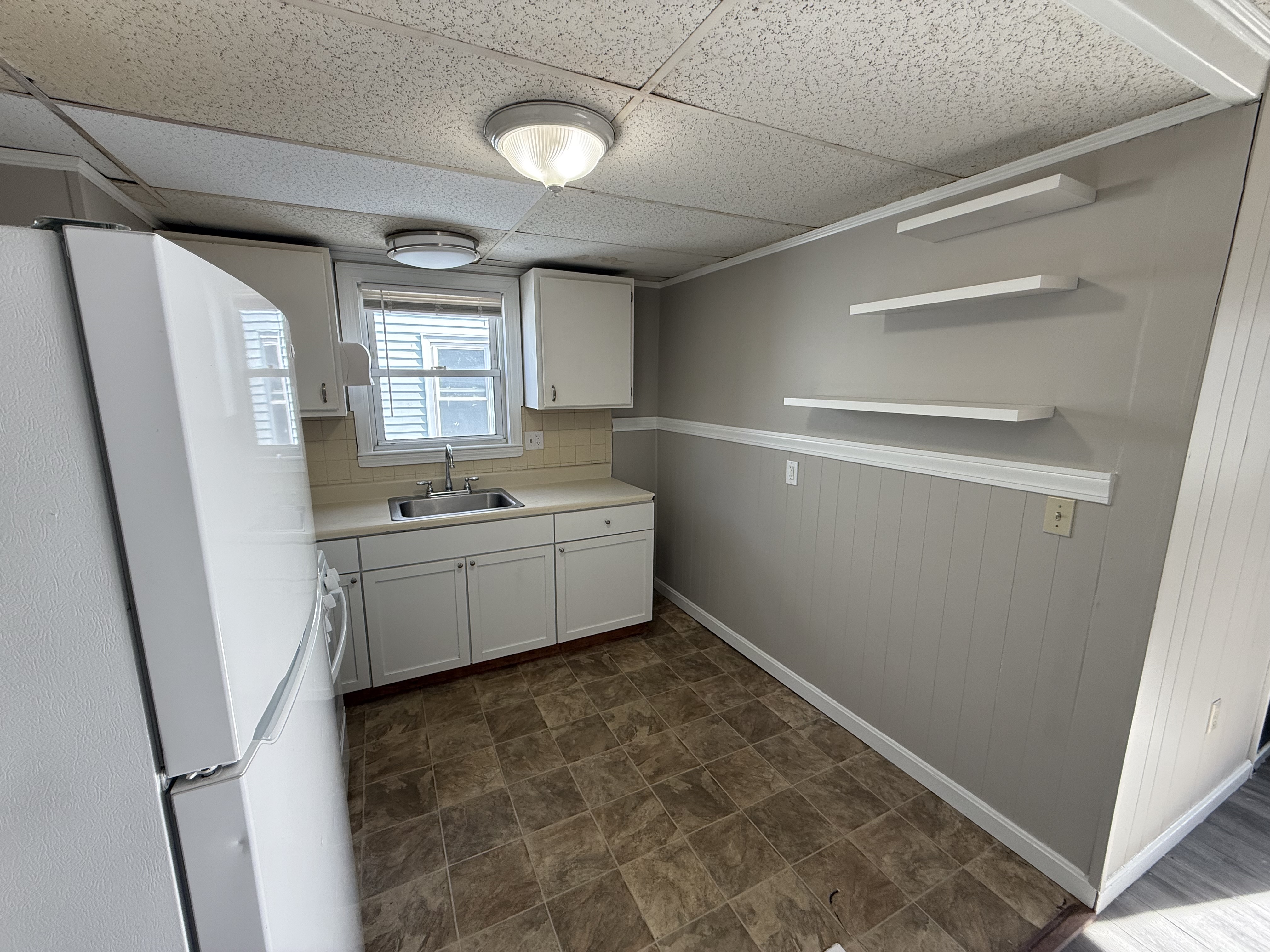 Kitchen detail with floating shelves and natural light