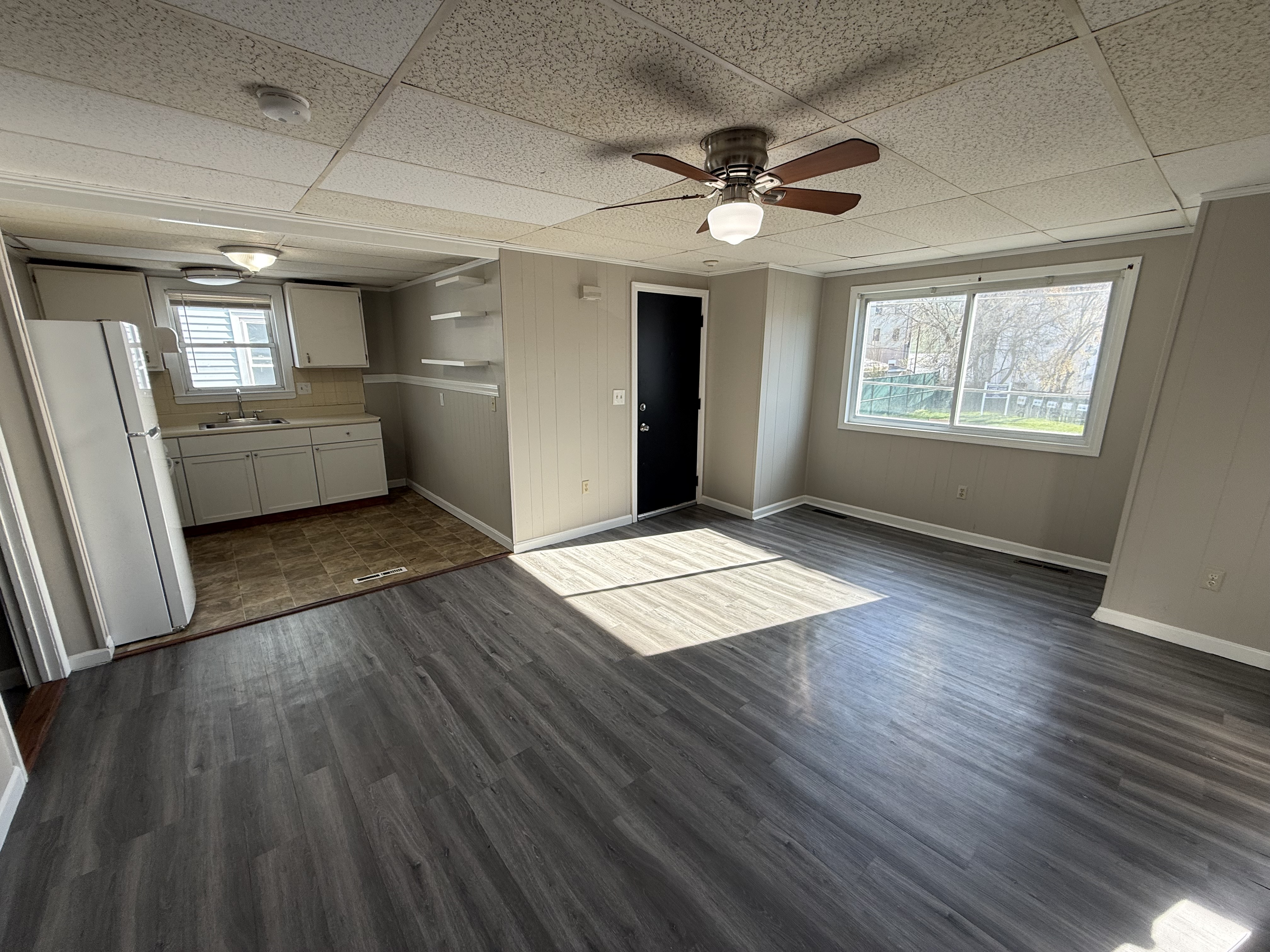 Open living room flowing into kitchen at 77 Massasoit St 2R Fall River MA