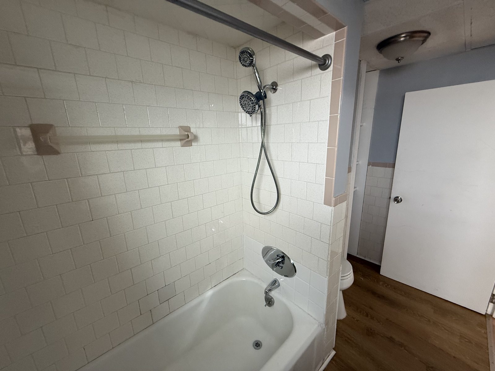 Bathroom shower with white tile surround in apartment 1N at 795 North Underwood Street Fall River MA
