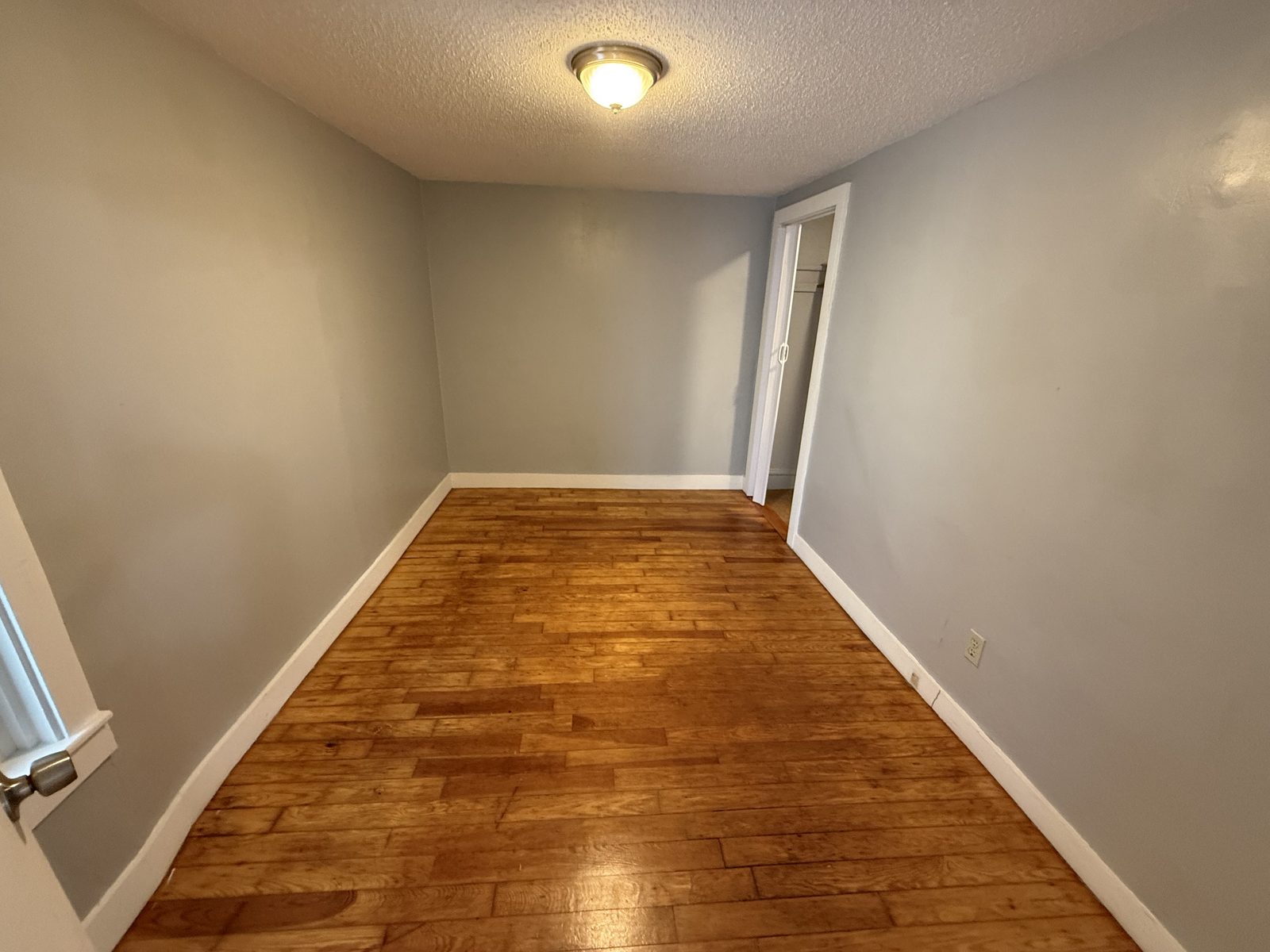 Bedroom 1 off the living room in apartment 1N at 795 North Underwood Street Fall River MA with hardwood floors and closet