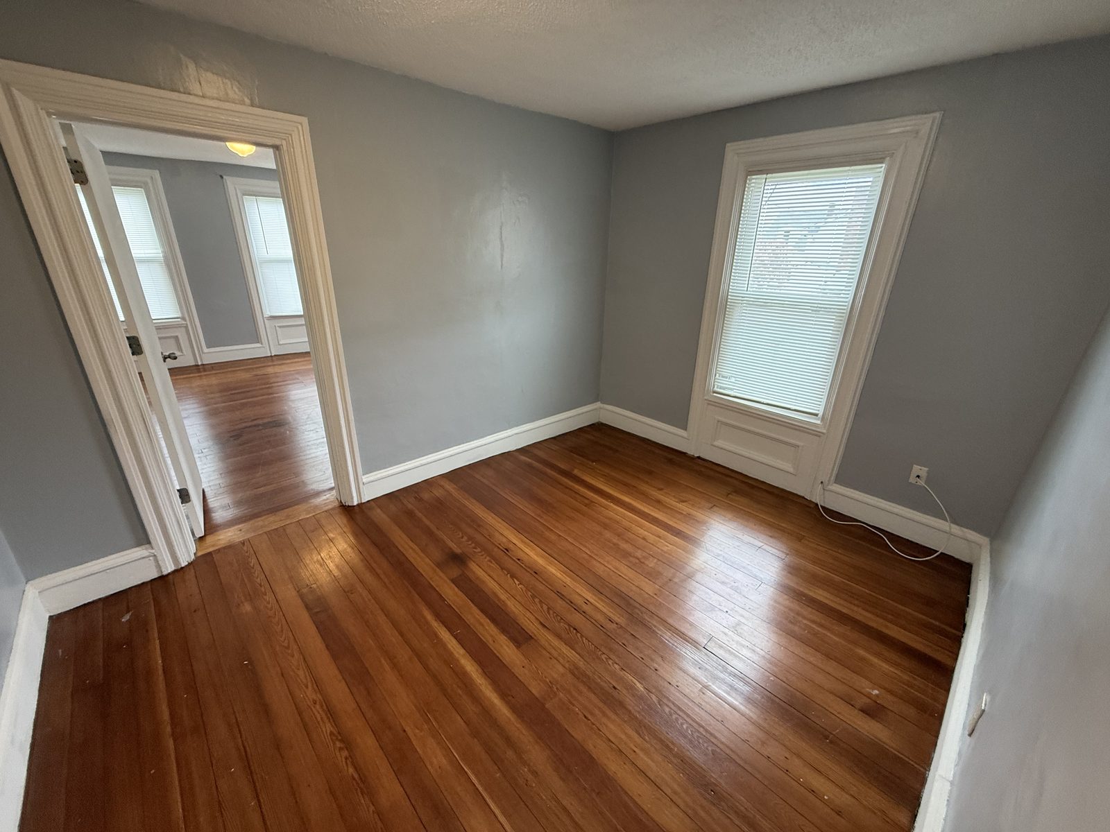 Flex room window view with original hardwood floors and tall window in apartment 1N at 795 North Underwood Street Fall River MA